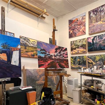 Artist's studio before clean up showing paintings and easel